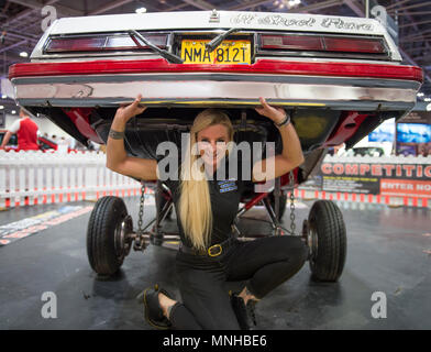 ExCel, Londres, Royaume-Uni. 17 mai, 2018. L'Confused.com London Motor Show event se déroule du 17 au 20 mai 2018 avec un espace 4,5 fois plus grand que l'an dernier. Photo : Jeune femme semble soulever une voiture personnalisée sur le Motor Show Events stand. Credit : Malcolm Park/Alamy Live News. Banque D'Images