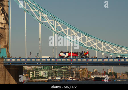 Vue d'un open top bus à impériale de Londres et les piétons allant sur Tower Bridge, Londres avec la Tamise et bateaux à voir ci-dessous Banque D'Images