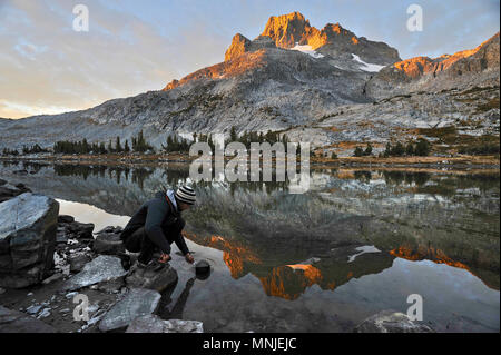 De l'eau Backpacker dips au camp près de Thousand Island Lake avec des bannières en arrière-plan pointe sur un trek de deux semaines de la Sierra en Haute Route Minarets Wilderness, Banque D'Images