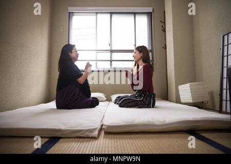 Mère et fille asiatique parle à la maison Banque D'Images