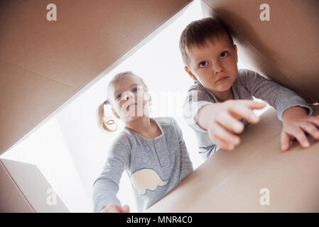 Deux petits enfants un garçon et fille boîte en carton et d'ouverture à l'intérieur avec surprise Banque D'Images