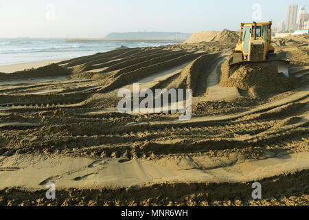 Durban, le KwaZulu-Natal, Afrique du Sud, jaune sable, plage de mise à niveau de bulldozer projet de réparation sur le Golden Mile, en bord de mer paysage, earth moving Banque D'Images