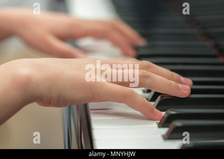 Les mains des enfants jouent du piano. La main de l'enfant sur les touches de piano Banque D'Images