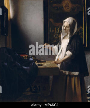 Johannes Vermeer Dutch, 1632 - 1675 Femme détenant un solde, ch. 1664 huile sur toile, brancard taille : 42,5 x 38 cm (16 3/4 x 15 in.) surface peinte : 39,7 x 35,5 cm (15 7/8 x 14 in.) National Gallery of Art, Washington Widener Collection English : femme détenant un solde de 1665. 1272 femme détenant un solde (Vermeer) Banque D'Images