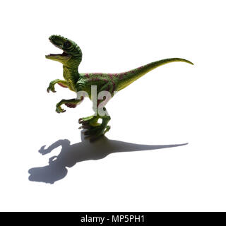 Velociraptor jaune jouet sur un fond blanc avec ombre Banque D'Images