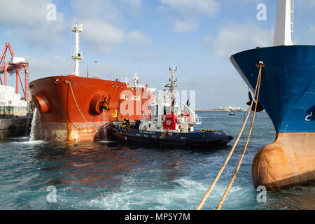 Pompage de pétroliers comme l'eau de ballast de navires remorqueurs sur quai dans les guides port Banque D'Images