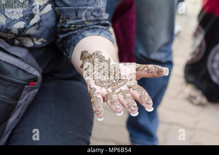 L'art et la diversité. Un gros plan d'une femme avec la main de conception, mehndi appliquée par un artiste à l'henné Shilparamam arts & crafts village, Hyderabad, Inde. Banque D'Images