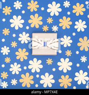 Heureux le jour de père bleu foncé et jaune arrière-plan coloré. Beau noeud papillon en bois et d'aujourd'hui mise à plat floral. Fête des pères carte de vœux. Banque D'Images