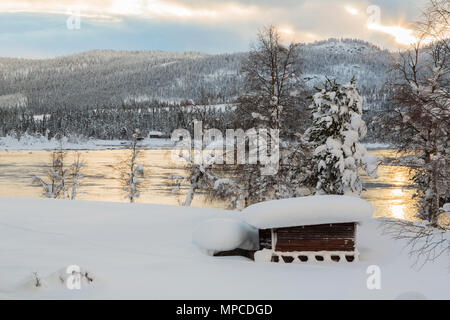 Paysage d'hiver en Tjåmotis avec montagnes en arrière-plan, le soleil brille sur les montagnes, l'eau du ruisseau avec open sky, avec de jolies couleurs reflétant dans t Banque D'Images