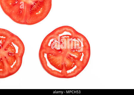 Tranche de tomate mûre rouge Vue de dessus isolé, concept fruits et légumes Banque D'Images