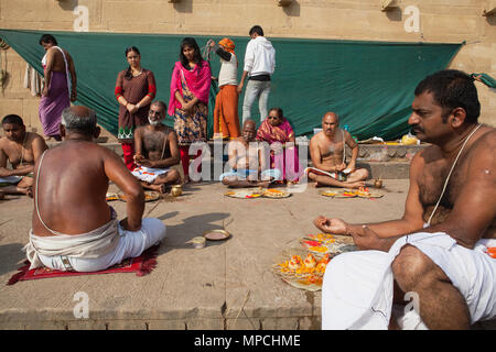 L'Inde, Uttar Pradesh, Varanasi, une famille endeuillée participer à une puja pour un parent décédé sur les ghats. Banque D'Images