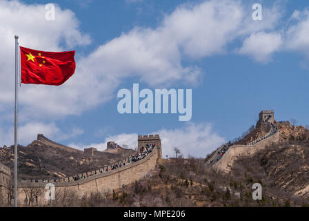 Beijing, Chine - 28 Avril 2010 : Grande Muraille de Chine à Badaling. Drapeau chinois à l'avant et le mur avec des gens people ascending stairs Retour en haut. Sur les montagnes Banque D'Images