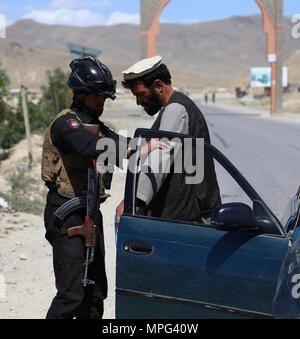 Ghazni, en Afghanistan. 22 mai, 2018. Un membre de la sécurité afghane cherche un homme à un point de contrôle après les attaques des talibans sur le DIH Yak et Jaghato dans les districts de la ville de Ghazni, capitale de la province de Ghazni, Afghanistan, le 22 mai 2018. Au moins 12 policiers, dont deux officiers supérieurs de la police, ont été tués dans des affrontements avec des militants talibans dans l'est de la province de Ghazni d'Afghanistan du jour au lendemain, a déclaré mardi un responsable local. Credit : Sayed Mominzadah/Xinhua/Alamy Live News Banque D'Images