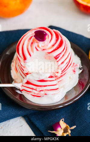 L'eau de rose orange sanguine et glace vanille servie sur une assiette. Arrière-plan de pierre blanche. Banque D'Images