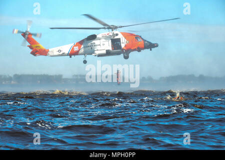 Un étudiant du Centre de formation technique à l'aviation d'Elizabeth City, Caroline du Nord, plonge d'un hélicoptère MH-60 Jayhawk de la station aérienne Elizabeth City dans la rivière Pasquotank le 14 février 2017. Quatre techniciens de survie aérienne A étudiants de l'ATTC ont obtenu leur diplôme et sont devenus ASTS le 17 février 2017. La formation portait sur l'évacuation de l'eau par hélicoptère, les procédures d'urgence et le développement des compétences de survie pour les missions de sauvetage en aviation. Banque D'Images