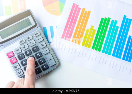 Financial Business graphique avec main sur calculatrice . Concept d'économiser de l'argent . Banque D'Images