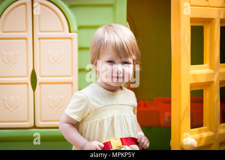 18 mois, fille, enfant jouant dans sa play house Banque D'Images