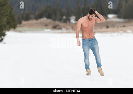 Beau jeune modèle soyons forts à l'extérieur et Flexing Muscles musculaire Bodybuilder Athlétique - Man - un lieu pour votre texte Banque D'Images