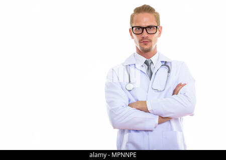 Studio shot of young handsome man doctor with arms crossed Banque D'Images