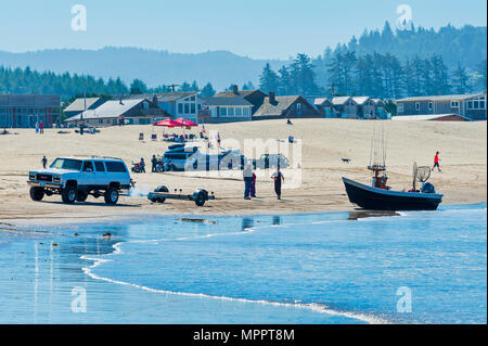 Pacific City, Oregon, USA - 2 juillet 2015 : un SUV 4 roues arrière d'un bateau remorque jusqu'à son bateau dory car elle se situe sur la plage de sable de Pacific City, Oregon Banque D'Images