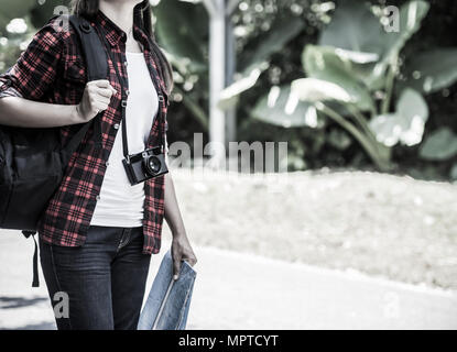 Style rétro de l'asian girl holding plan avec sac à dos à la route et l'arrière-plan de la forêt, vous pourrez vous détendre en vacances le temps de voyage concept. Banque D'Images