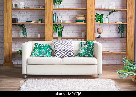 Lumière confortable avec canapé blanc, plantes et d''un mobilier élégant dans un style scandinave. Intérieur salon concept. Focus sélectif. L'espace pour le texte. Banque D'Images