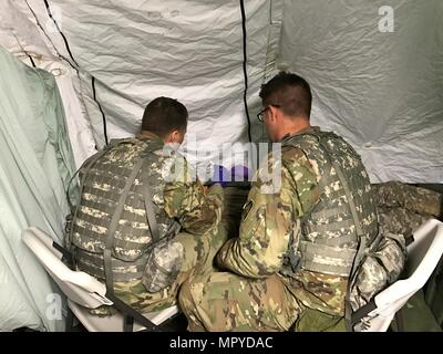 Deux soldats administrer une aide médicale à un soldat avec une blessure à l'œil dans Charlie Med, la Compagnie C, 113e Bataillon de soutien de la Brigade d'infanterie, 76e Brigade Combat Team au cours de l'exercice d'entraînement de printemps en préparation pour Joint Readiness Training Center, rotation # JRTC, plus tard cet été. (Photo : le Maj Chris Matthews) Banque D'Images