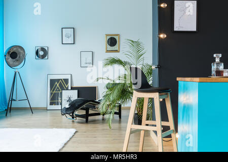 Les disques vinyles et designer lampe dans ce studio spacieux avec un tabouret à l'île de cuisine Banque D'Images