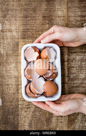 A woman holding broken egg shells Banque D'Images