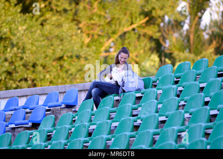 MINSK, BELARUS - 23 MAI 2018 : jeune mère avec son bébé sur le podium du stade pendant le match de football Premier League biélorusse entre Dinamo Minsk et FC Bate au stade du tracteur. Banque D'Images