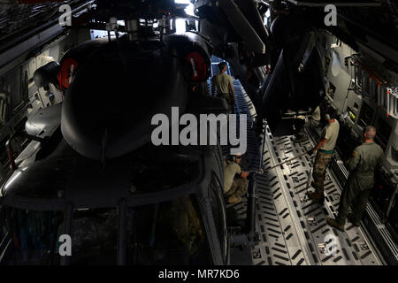 Les membres du 723e Escadron de maintenance d'hélicoptères, 41e Unité de maintenance affecté à Moody Air Force Base, Ga., positionner un HH-60G Pave Hawk hélicoptère de recherche et sauvetage Le 15 mai sur un escadron de transport aérien 3d C-17 Globemaster III à Moody AFB. La 41e HMU aviateurs a travaillé dans l'unisson en suivant les instructions de la Tech. Le Sgt. Brendan Proctor, 3e comme arrimeur. (U.S. Air Force photo par Aaron J. Senior Airman Jenné) Banque D'Images