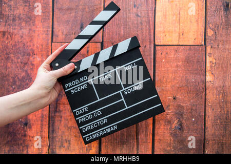Les plaques à clapet, women's hands et clapper film sur un fond de bois Banque D'Images