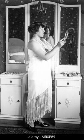 La mode, femme en robe de soirée se tient devant un miroir, 1920, Allemagne Banque D'Images