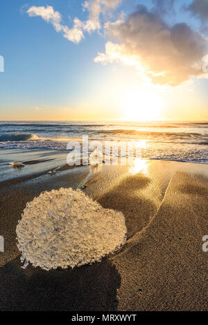 L'Est, l'Islande, l'Islande, le nord de l'Europe. L'emblématique peu icebergs sur la bordée d'une plage de sable noir. Banque D'Images