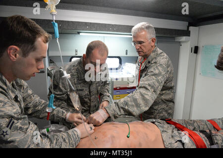 Le Lieutenant-colonel de l'US Air Force Dwight Harley, droite, donne des instructions pour le s.. Daniel Wagner, centre, et d'un membre de la 1re classe Thomas Sorum, tous de la 119e Groupe médical, qu'ils fréquentent à l'état de l'art qui agit comme un mannequin simulateur de patient humain lors d'un scénario de formation médicale au Camp Gilbert C. Grafton, près de Devils Lake, N.D., le 21 juillet 2017. Le Mannequin simulateur humain réaliste et équipements associés fournir des soins pré-hospitaliers et les soins d'urgence de formation pour le personnel médical similaire à ce qu'ils pourraient trouver dans la base d'opérations ou à distance. (U.S. La Nati Banque D'Images