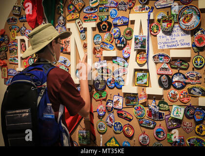 Le Scout les bornes L'un de ses patches au Pin-a-Patch wall au sommet au cours de la réserve de Bechtel 2017 Jamboree National près de Glen Jean, W.Va., le 21 juillet 2017. Le Jamboree National 2017 est fréquentée par 30 000 scouts, chefs de troupes, les bénévoles et les membres du personnel professionnel, ainsi que plus de 15 000 visiteurs. Environ 1 200 militaires du ministère de la Défense nationale et la garde côtière des États-Unis sont de fournir un soutien logistique pour l'événement. (U.S. Photo de l'armée par la CPS. Liem Huynh/22e Détachement des affaires publiques mobiles) Banque D'Images