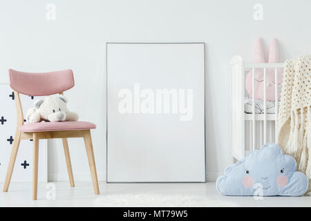 Peluche sur chaise rose et bleu coussin dans la chambre de l'enfant intérieur avec une maquette de l'affiche. Photo réelle. Collez votre graphique ici Banque D'Images