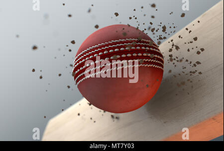 Un gros plan extrême action slow motion capture d'un cricket ball rouge trouver un bâton de bois avec des particules de terre provenant d'un contexte isolé sombre Banque D'Images