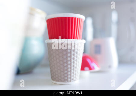 Verres en plastique empilés sur des étagères blanches. Focus sélectif. Close up. Banque D'Images