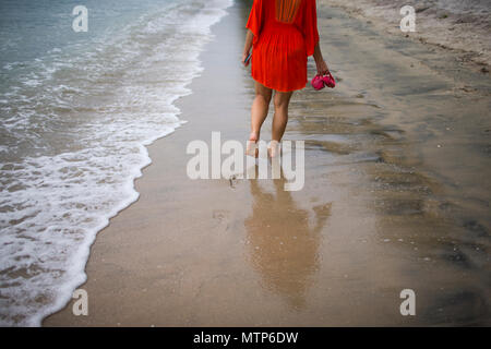 Une femme blonde déambule le long de la plage au Damai Laut en Malaisie. Banque D'Images