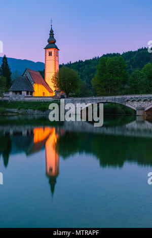 L'église Saint Jean le Baptiste au lac de Bohinj. Le lac de Bohinj est le plus grand lac permanent en Slovénie. Il est situé dans la vallée de Bohinj de th Banque D'Images