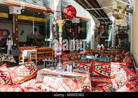 Vide café turc dans le style traditionnel - textiles lumineux et des oreillers avec narguilé debout sur la table Banque D'Images