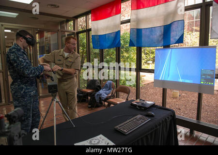 BANGOR, Washington (27 avril 2017) Le lieutenant Cmdr. Chris Keithley, droit, de Valparaiso, Indiana, attribué à, commandant de la force sous-marine, de la Flotte du Pacifique des États-Unis, montre Technicien Sonar 1re classe Greg Goldsberry, de Spokane, Washington, attribué à l'équipage du bleu de classe Ohio-balistique sous-marin SNLE USS Louisiana (743), la façon d'utiliser le casque de réalité virtuelle, l'HTC Vive, au cours de l'Innovation Lab (iLab) roadshow tenue au Centre de formation de Trident Bangor. Le iLab, qui est situé au centre d'instruction navale sous-marine, du Pacifique à Pearl Harbor, Hawaii, est une initiative lancée pour stimuler le rapi Banque D'Images