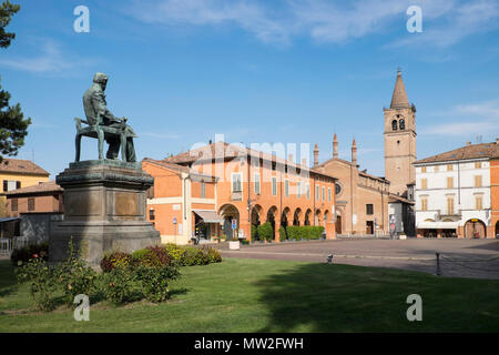 L'Italie, Émilie-Romagne : Busseto, statue de Giuseppe Verdi de l'ÒPiazza VerdiÓ square. Dans l'arrière-plan, l'église de San Bartolomeo Banque D'Images