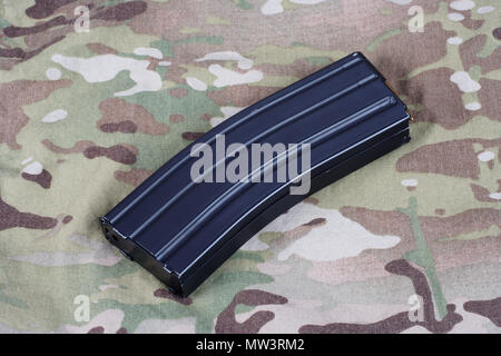 Fusil M16 magazine avec des cartouches sur fond uniforme de camouflage Banque D'Images