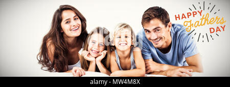 Image composite de happy family lying on a bed Banque D'Images