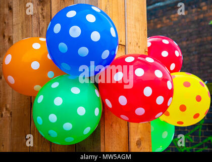 Des ballons multicolores avec des taches accrochée à un mur en bois Liverpool Mai 2018 Banque D'Images