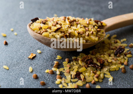 Boulgour de sarrasin avec du riz brut en cuillère en bois / Boulgour pour Pilav ou Pilaf. Les aliments crus biologiques. Banque D'Images