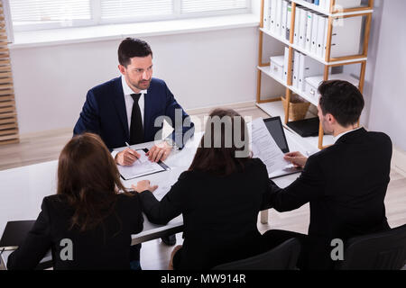 High Angle View of Young Businesspeople Having Conversation in Office Banque D'Images