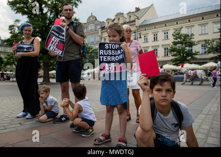 Cracovie, Pologne. 1er juin 2018. Une famille ukrainienne détient les cartes rouges et des banderoles au cours d'une manifestation pour réclamer la libération du cinéaste et écrivain ukrainien, Oleg Sentsov à la place principale de Cracovie.Oleg Sentsov a été condamné par un tribunal russe le 25 août 2015 à 20 ans pour la planification d'une attaque terroriste à la péninsule de Crimée, annexée par la Russie en avril 2014. Credit : Omar Marques/SOPA Images/ZUMA/Alamy Fil Live News Banque D'Images